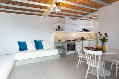 a white living room with a white couch and a table at ELiteDIMension in Rhodes Town