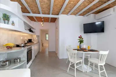 a kitchen and dining room with a table and chairs at ELiteDIMension in Rhodes Town