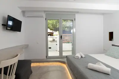 a bedroom with a bed with two towels on it at ELiteDIMension in Rhodes Town