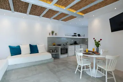 a living room with a white couch and a table at ELiteDIMension in Rhodes Town