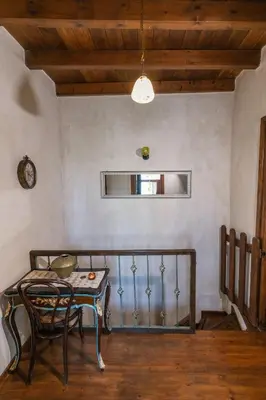 a table and chair in a room with a wall at OLD TOWN CLASSIC HOUSE RHODES in Rhodes Town
