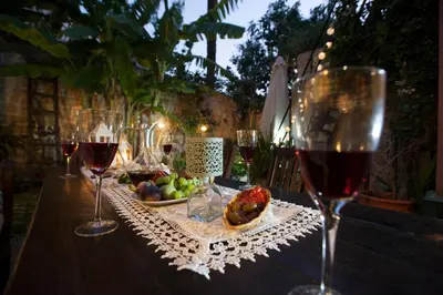 a table with glasses of wine and a bowl of fruit at OLD TOWN CLASSIC HOUSE RHODES in Rhodes Town