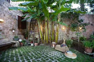 a courtyard with a bunch of plants and chairs at OLD TOWN CLASSIC HOUSE RHODES in Rhodes Town