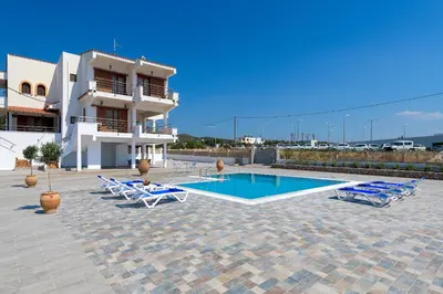 a villa with a swimming pool in front of a building at Villa Valasia in Gennadi