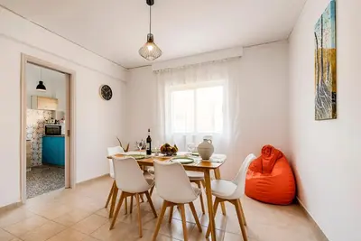 a kitchen and dining room with a table and chairs at Sunway Suite in Rhodes Town
