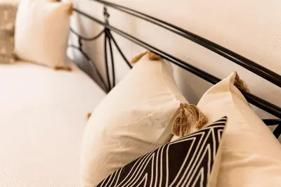 a black and white bed with two pillows on it at Sunway Suite in Rhodes Town