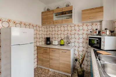 a kitchen with a refrigerator and a sink at Sunway Suite in Rhodes Town