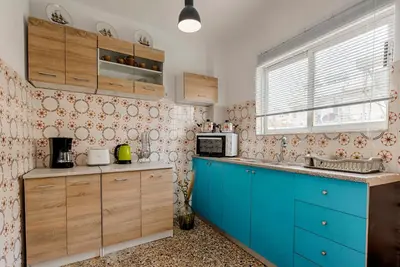 a kitchen with blue cabinets and a blue counter top at Sunway Suite in Rhodes Town