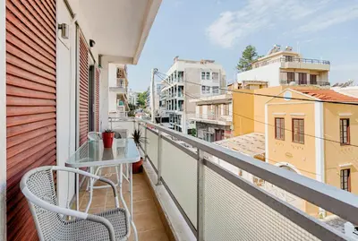 a balcony with a chair and a view of buildings at Sunway Suite in Rhodes Town