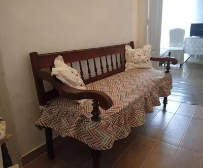 a wooden bench with two pillows on it at Marthas Traditional House in Symi