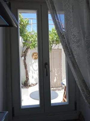 an open window with a view of a yard at Marthas Traditional House in Symi