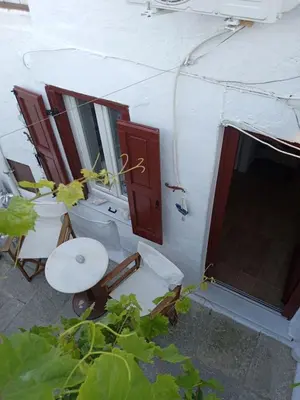 an outside view of a white tent with a door at Marthas Traditional House in Symi
