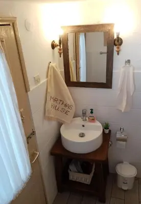 a bathroom with a sink and a mirror at Marthas Traditional House in Symi