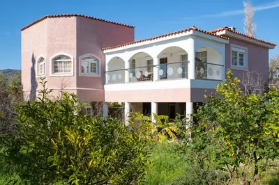 a house on the hill with trees at House of Paradise in front of the golf court-sea in Rhodes Town