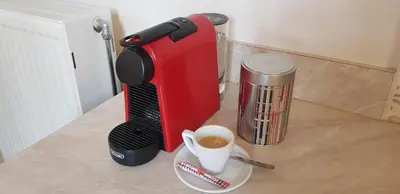a coffee maker sitting on a counter with a cup of coffee at MA-GIA in Pastida