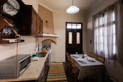 a kitchen with a dining table and a microwave at MA-GIA in Pastida