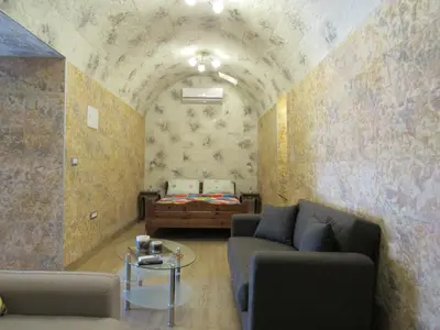 a living room with a couch and a bed at Pitini Sevasti house in Symi