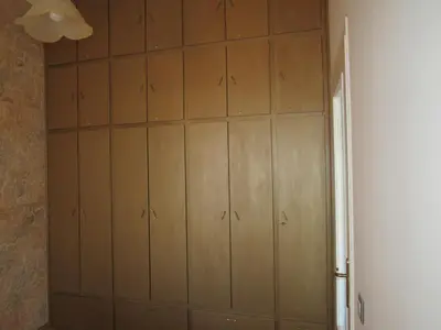 a closet with wooden panels on the wall at Pitini Sevasti house in Symi