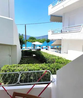 a shopping cart on a balcony with a view of the ocean at Haraki Memories Beach Studios in Haraki