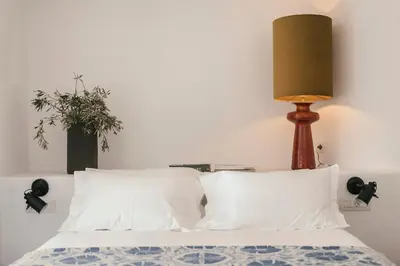 a bedroom with a bed with a lamp on it at Casita Casita Lindos - Adults Only in Líndos