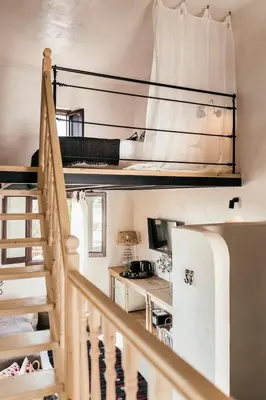 a staircase leading up to a room with bunk beds at Casita Casita Lindos - Adults Only in Líndos