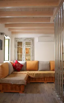 a living room with a large couch in a room at EVANNA HOUSE in Symi