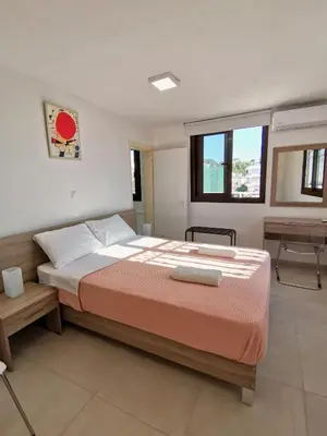 a bedroom with a large bed and a window at Loft for 2 in Rhodes town near Elli beach in Rhodes Town