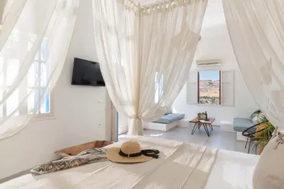 a hat sitting on a bed in a bedroom at Lindos Beach Boutique Villa in Líndos