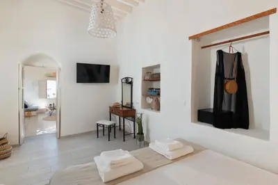 a white room with two towels on a bed at Lindos Beach Boutique Villa in Líndos