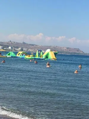a group of people in the water at the beach at RHODIAN TREASJURE Spiridione Studios in Faliraki