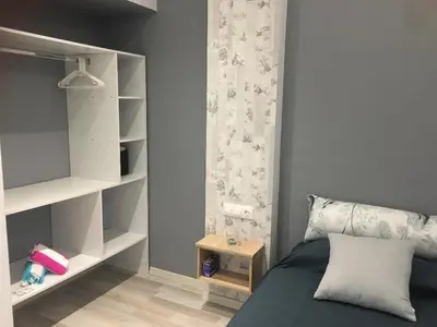 a bedroom with a bed and a book shelf at RHODIAN TREASJURE Spiridione Studios in Faliraki