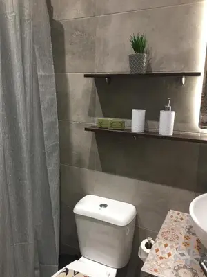 a bathroom with a white toilet and a sink at RHODIAN TREASJURE Spiridione Studios in Faliraki