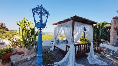 a gazebo with a bench and a street light at Archontiko Stegna in Archangelos