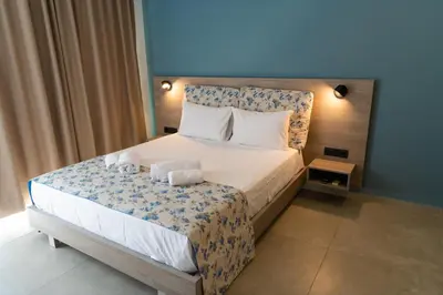a bedroom with a bed with two towels on it at Tesoro Del Mare in Pefki Rhodes
