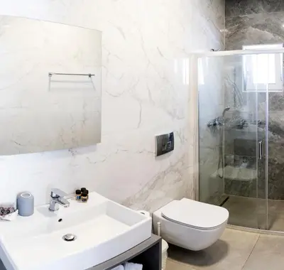 a bathroom with a sink and a toilet and a shower at Tesoro Del Mare in Pefki Rhodes