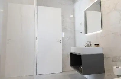 a white bathroom with a sink and a mirror at Tesoro Del Mare in Pefki Rhodes