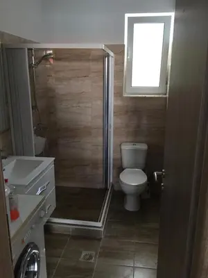 a small bathroom with a toilet and a window at TASSOS-Haus in Archangelos