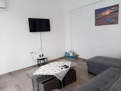 a living room with a couch and a table at TASSOS-Haus in Archangelos
