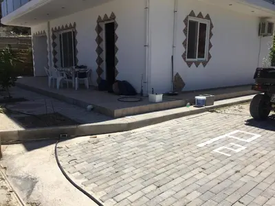 a white house with a patio and a table at TASSOS-Haus in Archangelos