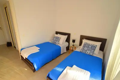 two beds in a room with blue and white at S-EVA RESORT in Kolimbia