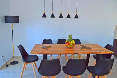 a dining room table with chairs and a bowl of fruit on it at S-EVA RESORT in Kolimbia
