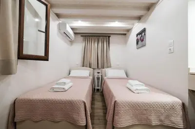 a room with two beds with towels on them at Old Town Diamond in Rhodes Town