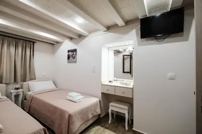 a hotel room with two beds and a mirror at Old Town Diamond in Rhodes Town