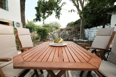 a wooden table with a plate of fruit on it at Old Town Diamond in Rhodes Town
