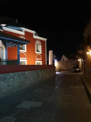 an orange and white building at night at Old Town Diamond in Rhodes Town