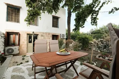 a table with a bowl of fruit on a patio at Old Town Diamond in Rhodes Town