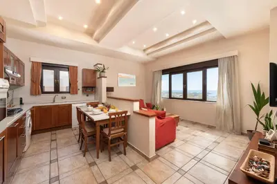 a kitchen and living room with a table and chairs at Blue Vision Luxury House in Pefki Rhodes