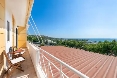 a balcony with a table and chairs on a roof at Blue Vision Luxury House in Pefki Rhodes