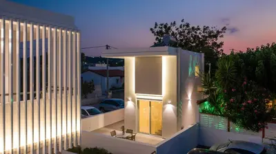 a view of a building at night at Avi Suites Faliraki in Faliraki