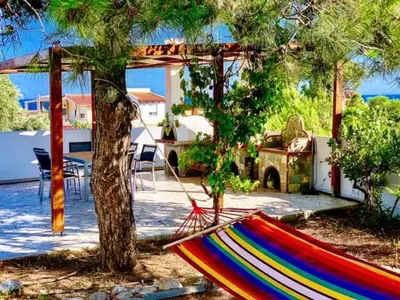 a colorful hammock in the yard of a house at Villa Papagiorgio Luxury and Harmony in Gennadi